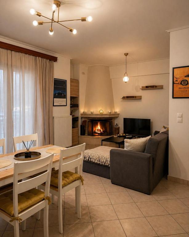 a living room with a couch and a table and a bed at H&H cozy retreat ,Fireplace and Parking in Piraeus