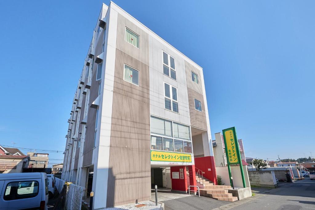 a building with a truck parked in front of it at Hotel Select Inn Sano-Ekimae in Sano