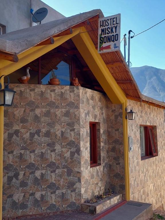 a building with a sign on top of it at Misky Sonqo in Tilcara