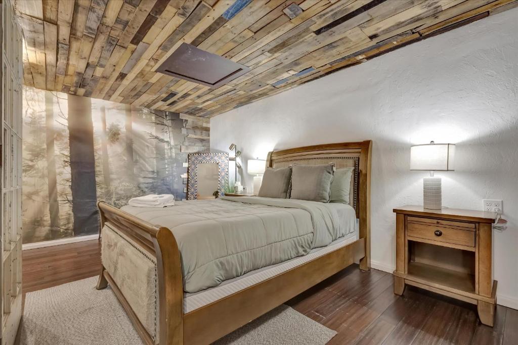 a bedroom with a large bed and a wooden ceiling at Peaceful Studio & Work Friendly Walk to Hyde Park in Tampa