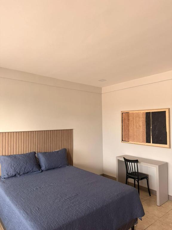a bedroom with a bed and a chair and a desk at Guayacan Real in Nicoya