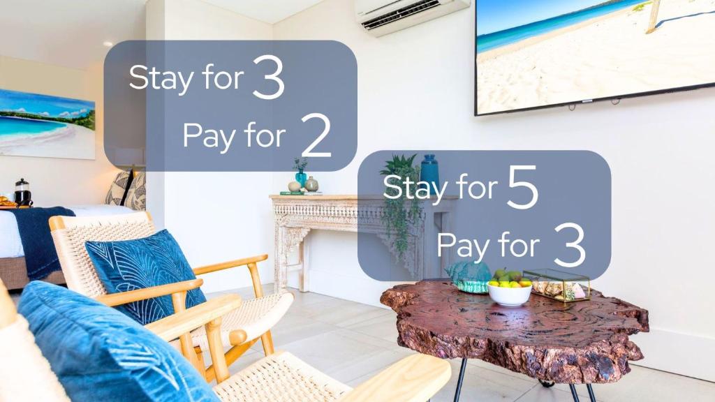 a living room with a table and a tv at Ishtar Apartment 8 by Book Jervis Bay - Luxury Studio in Huskisson