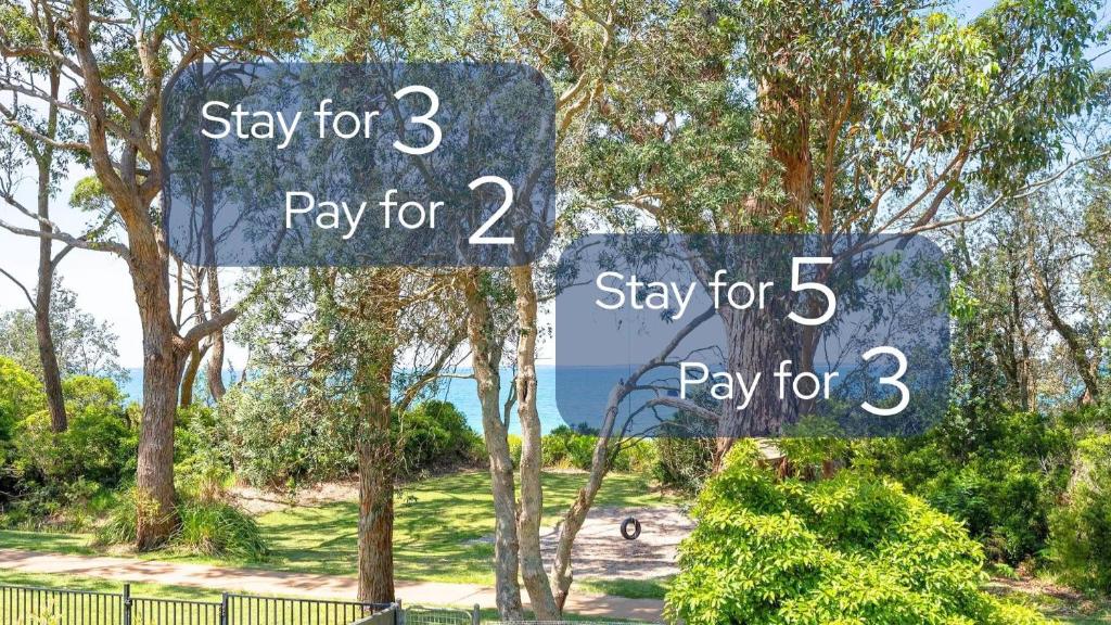 two signs that say pay for two and play for at Sabia Beach House by Book Jervis Bay - Beachfront - Sleeps 6 in Vincentia