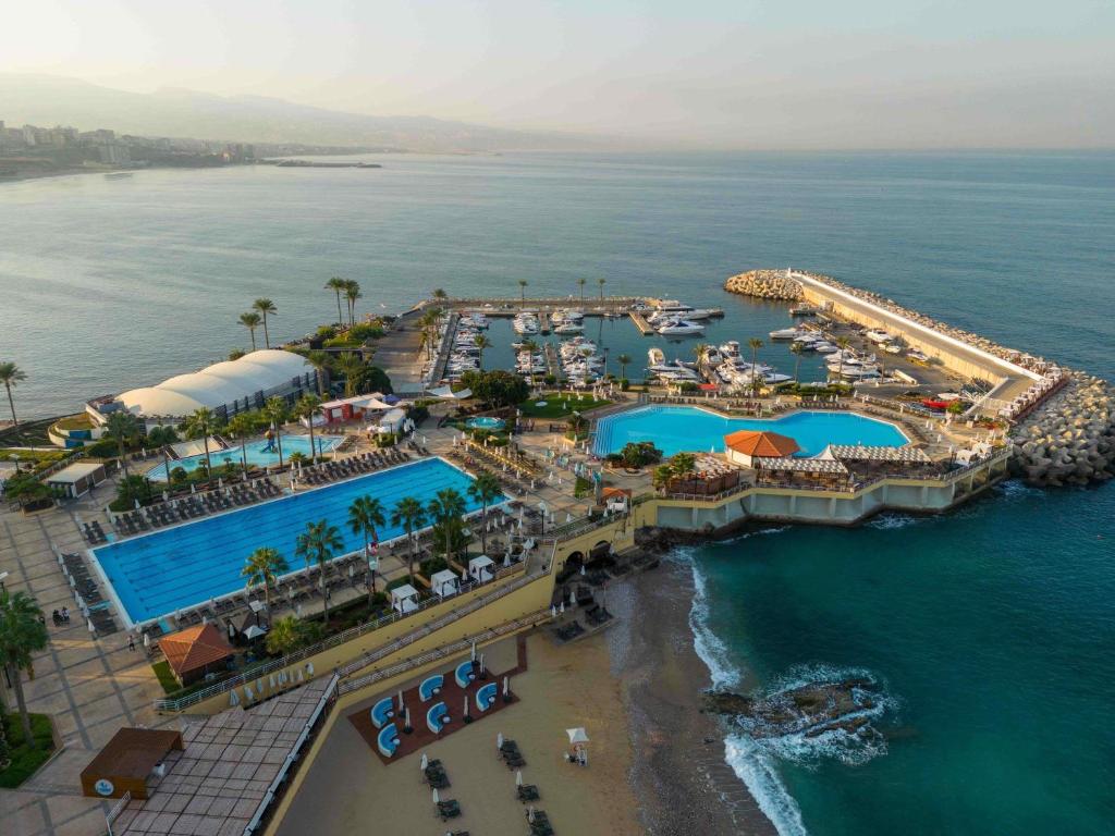 an aerial view of a resort next to the ocean at Mövenpick Hotel Beirut in Beirut