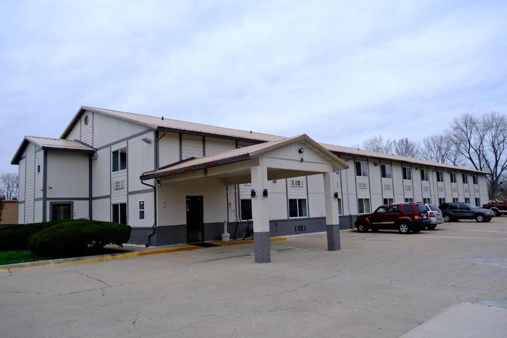 a large white building with a parking lot at FairBridge Inn Express Chesterton in Chesterton