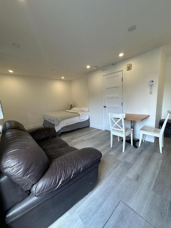 a living room with a couch and a bed and a table at Hotel Mini Inc in Montreal
