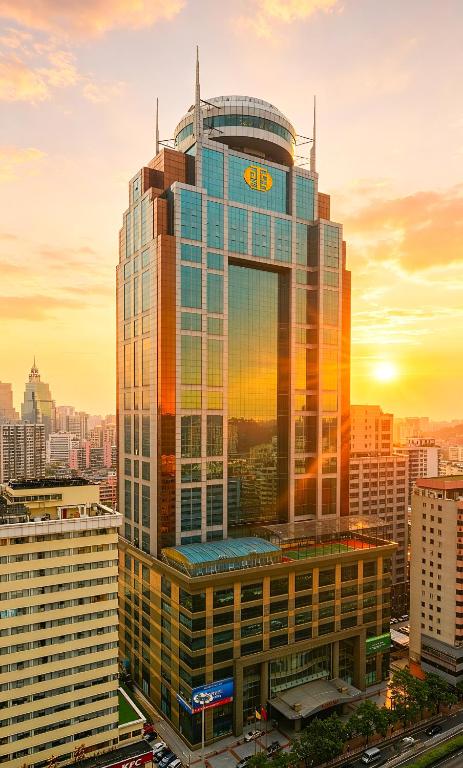 a tall building with a clock on top of it at Asia International Hotel Guangdong in Guangzhou