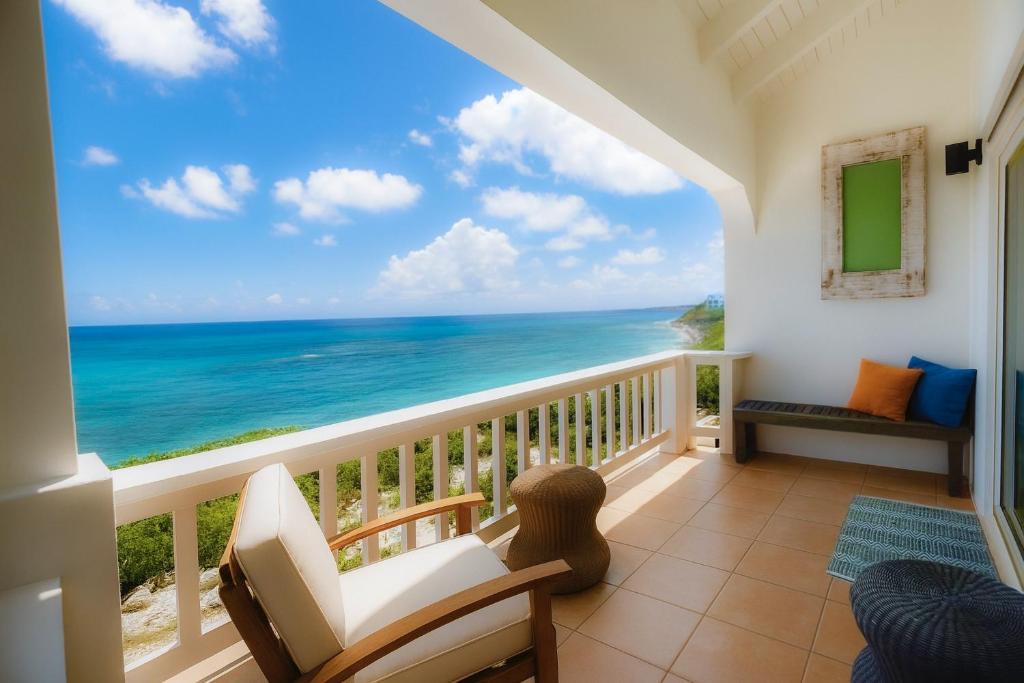 a balcony with a view of the ocean at Clearview Villas Upper in Island Harbour