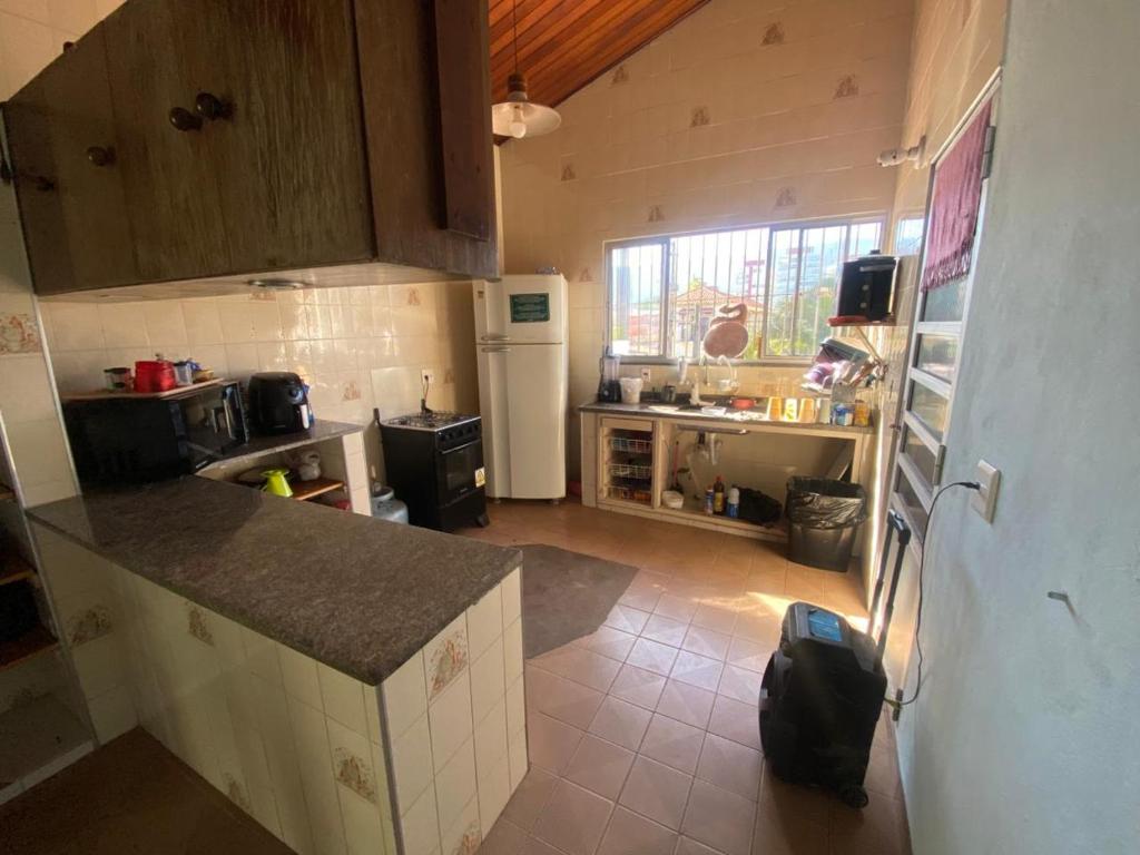 a kitchen with a counter top in a room at Sool Beach Hostel in Bertioga