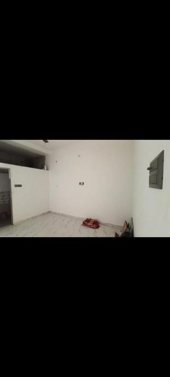 a room with a white wall and a room with a bed at Ajay kushwaha in Jabalpur