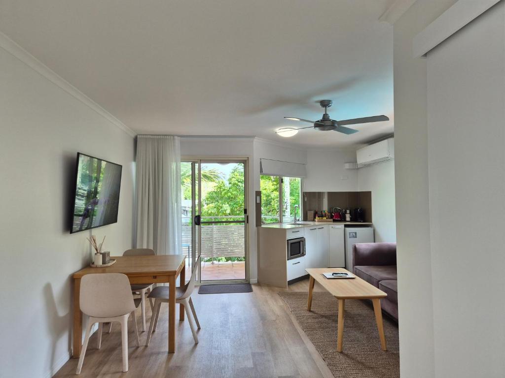 a living room with a couch and a table at Noosa Sun - On the Noosa River in Noosaville