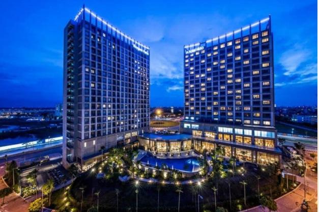a large building with a pool in front of it at 2BR Minato Apartment, Free Swimming Pool & Gym in Hai Phong