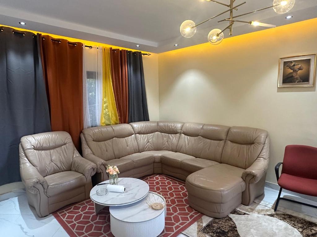 a living room with a couch and a table at Residence MBK Appartement A in Ziguinchor
