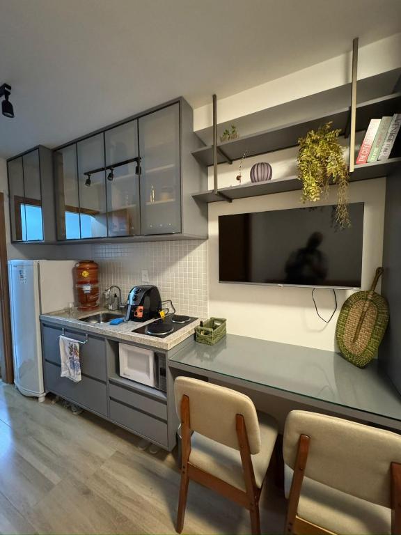 a kitchen with a counter and a stove top oven at Smart Pituba Studio Premium in Salvador
