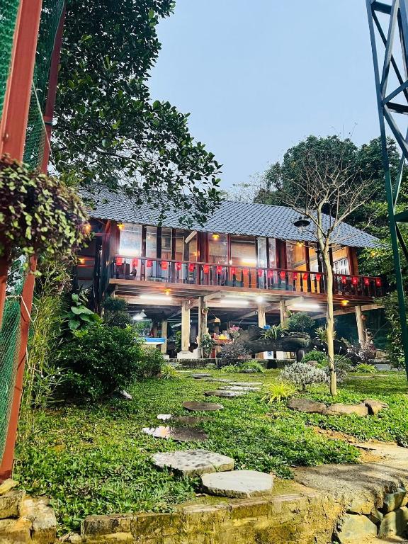 a house with a bridge in front of it at HomeStay Pickle ball in Ðồng Vo