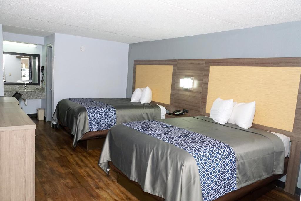 a hotel room with two beds in a room at Legacy Inn - Gallatin in Gallatin
