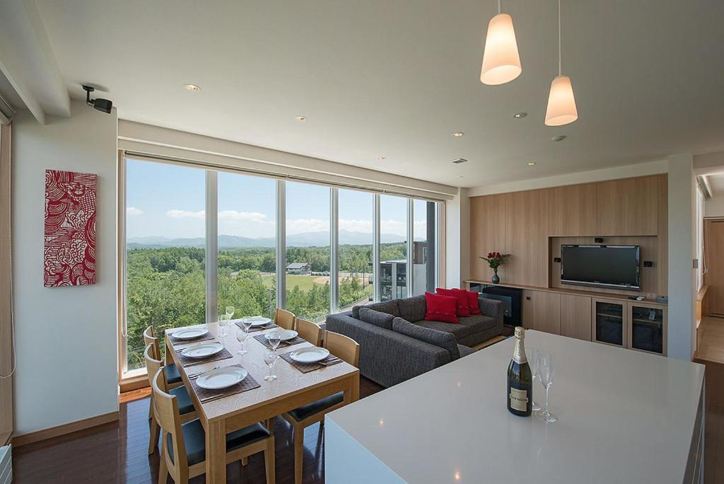 a kitchen and living room with a table and a couch at Snow Crystal in Kutchan