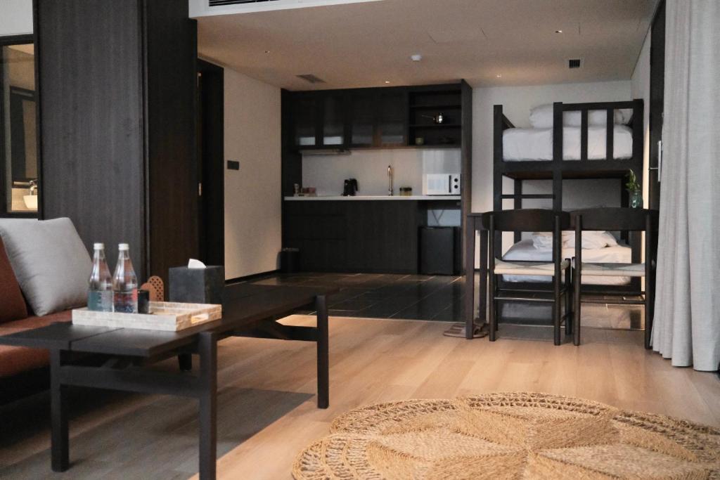 A family-style apartment living area with kitchenette and bunk beds.