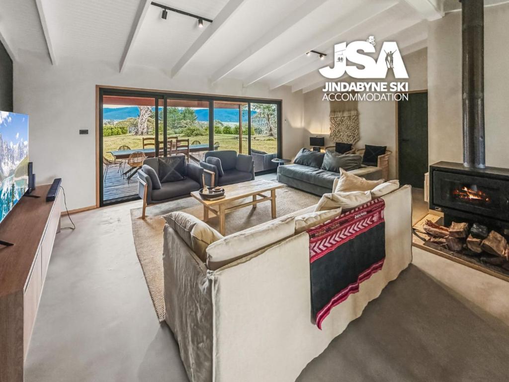 a living room with a couch and a fireplace at The Orchard in Moonbah