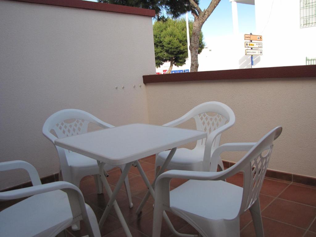 a white table and chairs on a patio at Hotel-Apartamento Carolina y Vanessa in San José