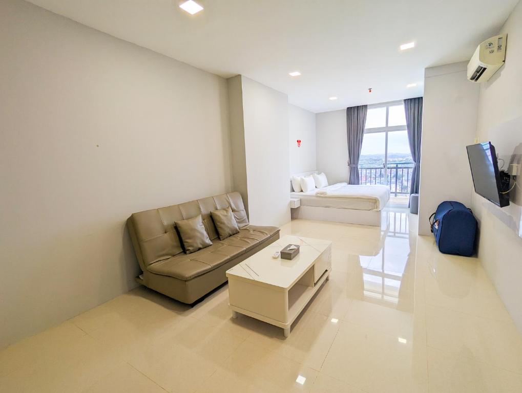 a living room with a couch and a table at Lovina Spacious Double Studio at Formosa Nagoya in Jodoh