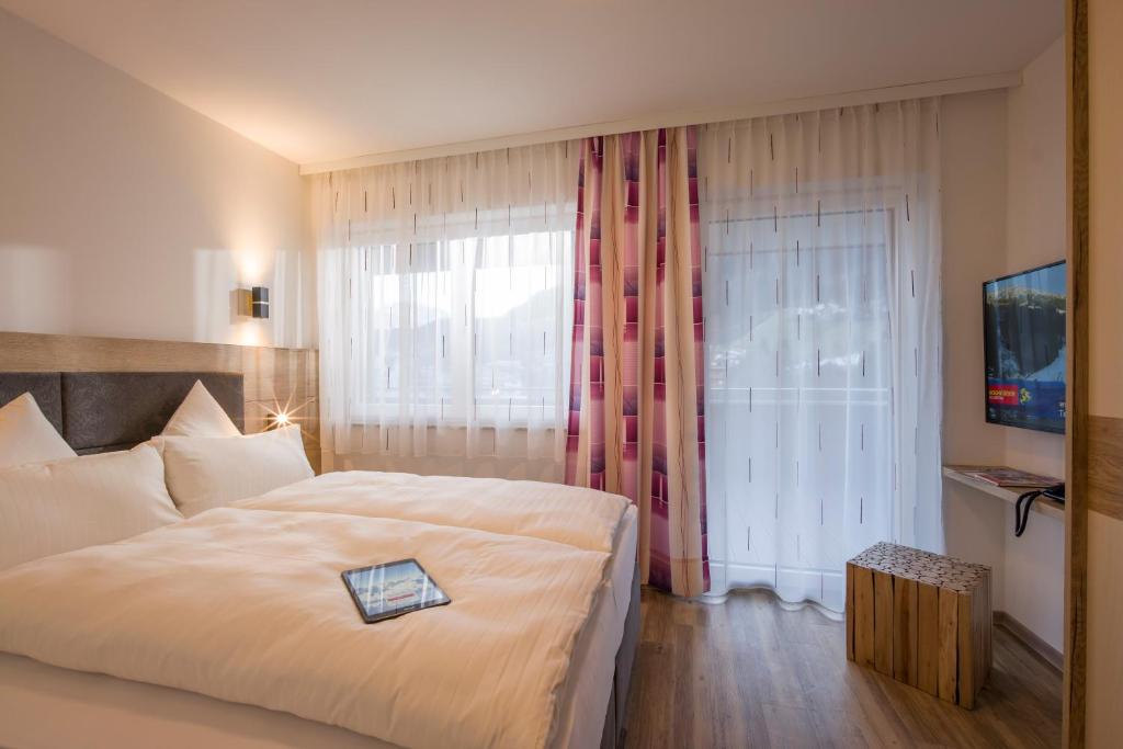 Postel nebo postele na pokoji v ubytování Aparthotel AlpTirol