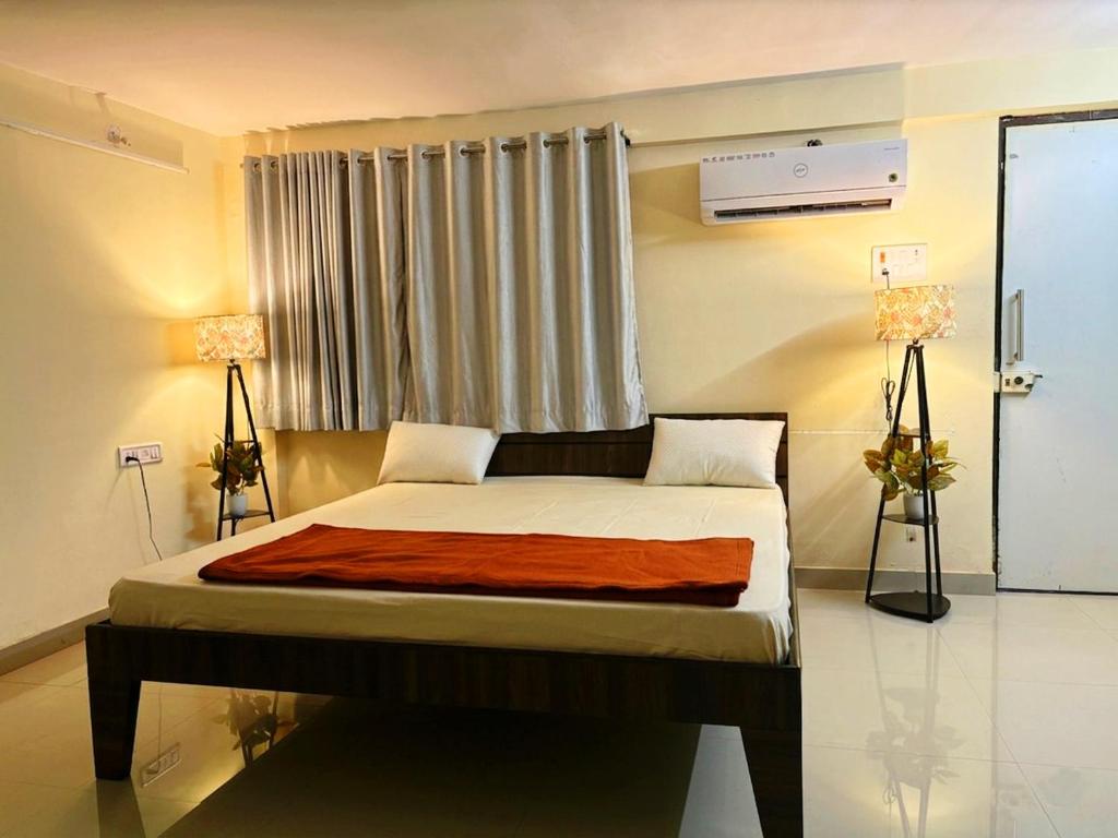a bedroom with a large bed with a window at Matoshree Green Garden Resort in Badlapur