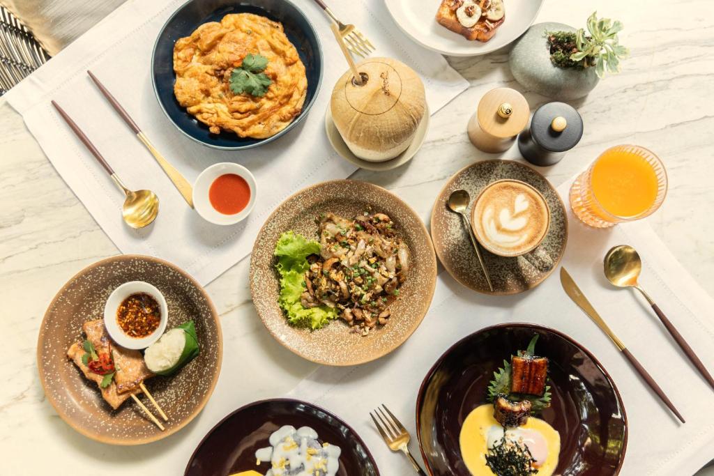 A generously styled table spread with plated dishes, coffee and juice.