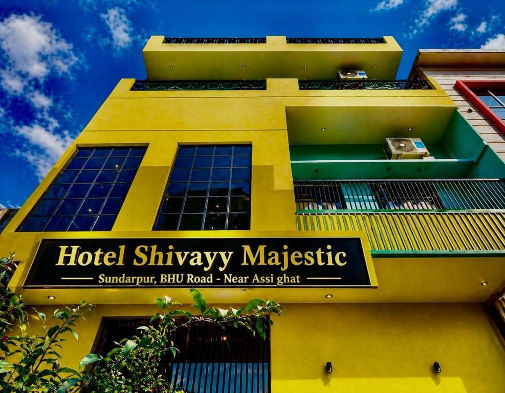 a yellow building with a sign for a hotel shinyasy majestic at HOTEL SHIVAYY MAJESTIC - BHU Sundarpur Road 3km from KASHI VISHWANATH TEMPLE in Varanasi