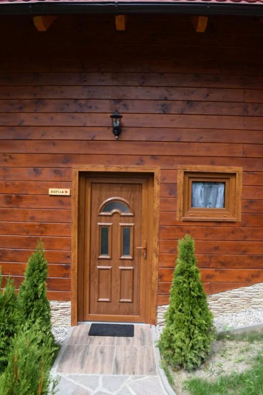 a wooden house with a door and a window at Chalet Wörthersee in Velden am Wörthersee