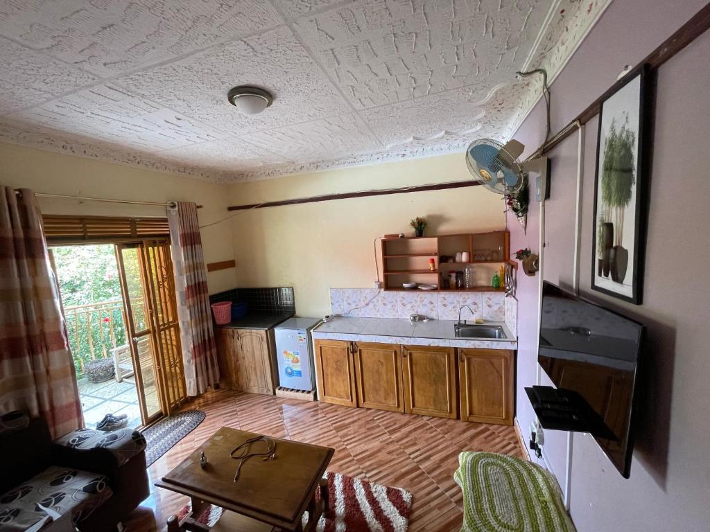 a small kitchen with a sink and a table at APARTMENT 01 Meadowbrook Home Stade in Kasaayi