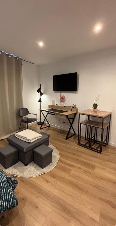 a living room with a flat screen tv on a wall at studio gray centre parking WiFi confort in Gray