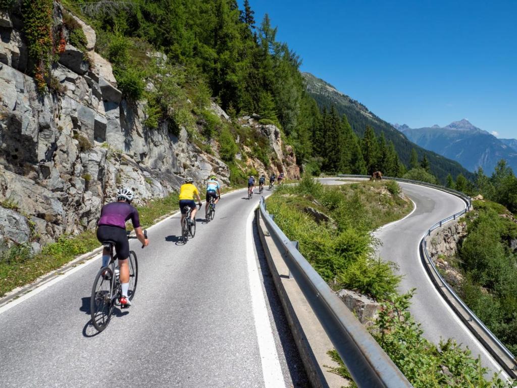 a group of people riding bikes down a road at STUDIO LE MONT-CENIS, GARAGE pour motards et cyclistes, gare a 800m in Fourneaux