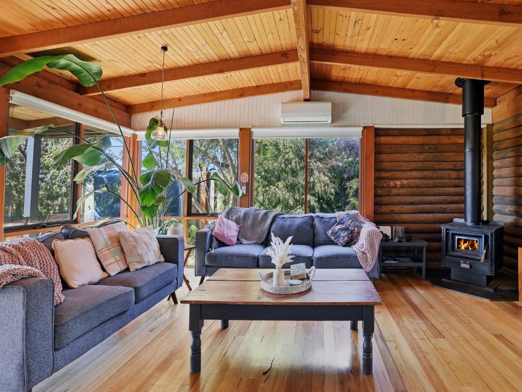 a living room with a couch and a stove at Prom Coast Oasis - Sandy Point in Sandy Point