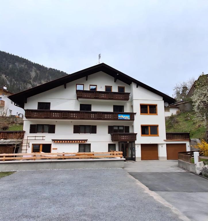 a building with a parking lot in front of it at Haus an der Sonne FeWo 1 in Biberwier