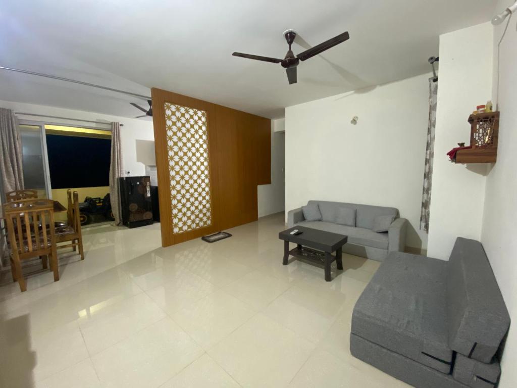 a living room with a couch and a table at Spacious 2BHK Mountain View - Near Palolem Beach in Canacona