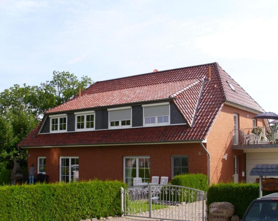 a brown brick house with a red roof at Große Auszeit in Gammendorf