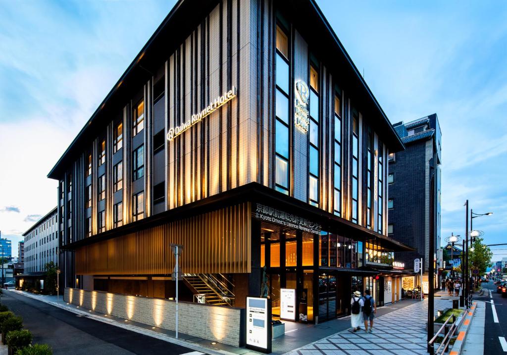 a building on a street with people walking in front of it at Daiwa Roynet Hotel Kyoto Ekimae PREMIER - former Daiwa Roynet Hotel Kyoto Ekimae in Kyoto