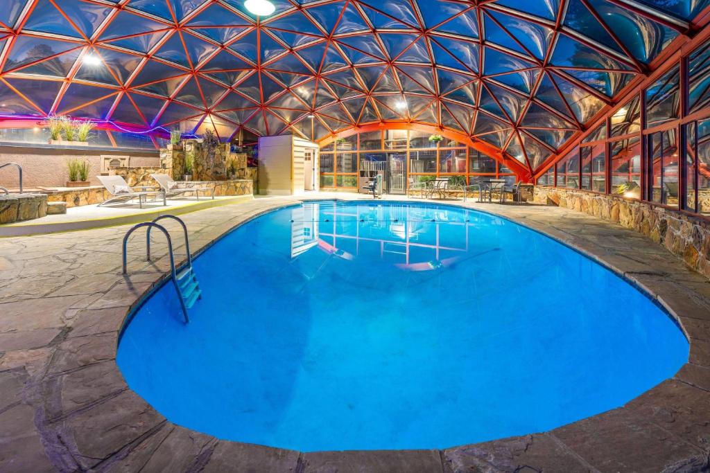 a large swimming pool in a building with a domed ceiling at Baymont by Wyndham Durango in Durango
