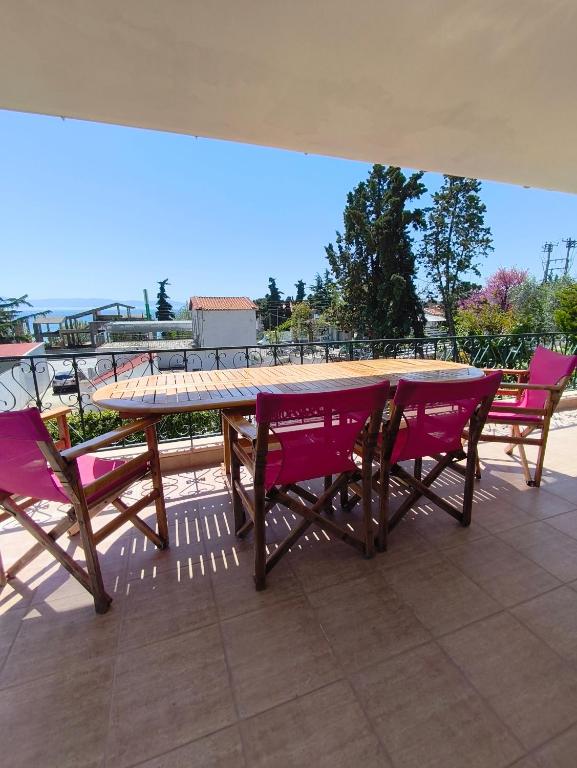 a wooden table and chairs on a patio at Palio Dream House in Paleo Tsifliki
