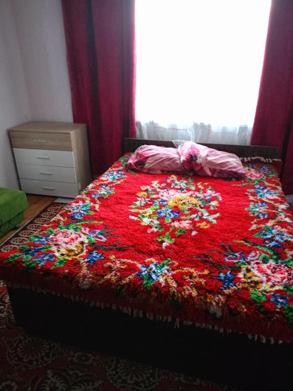 a bed covered in confetti in a bedroom at Pretty house in Panagyurishte