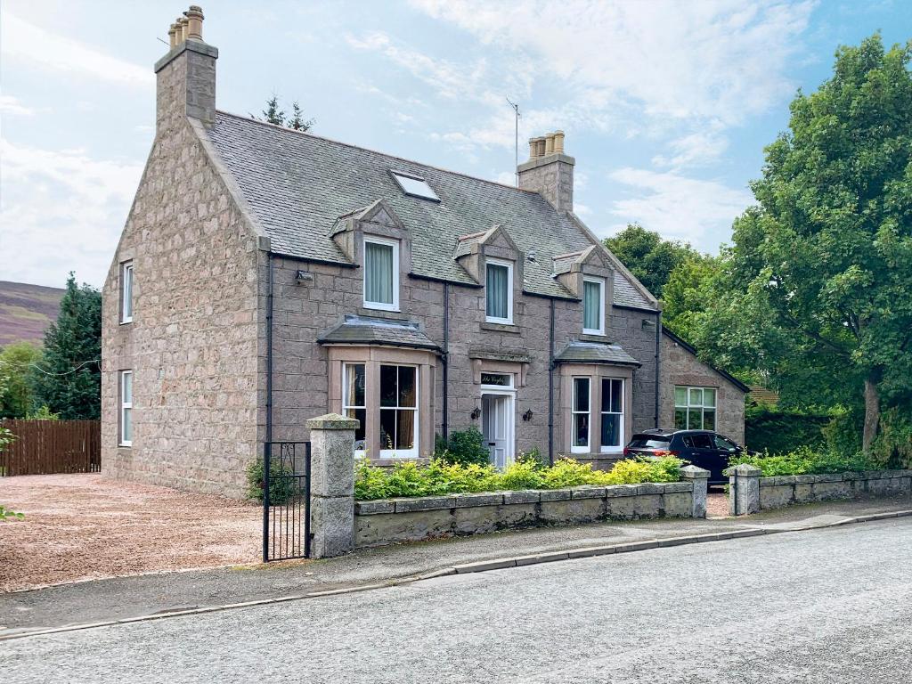 a large brick house on the side of a street at The Coyles - Uk31466 in Ballater