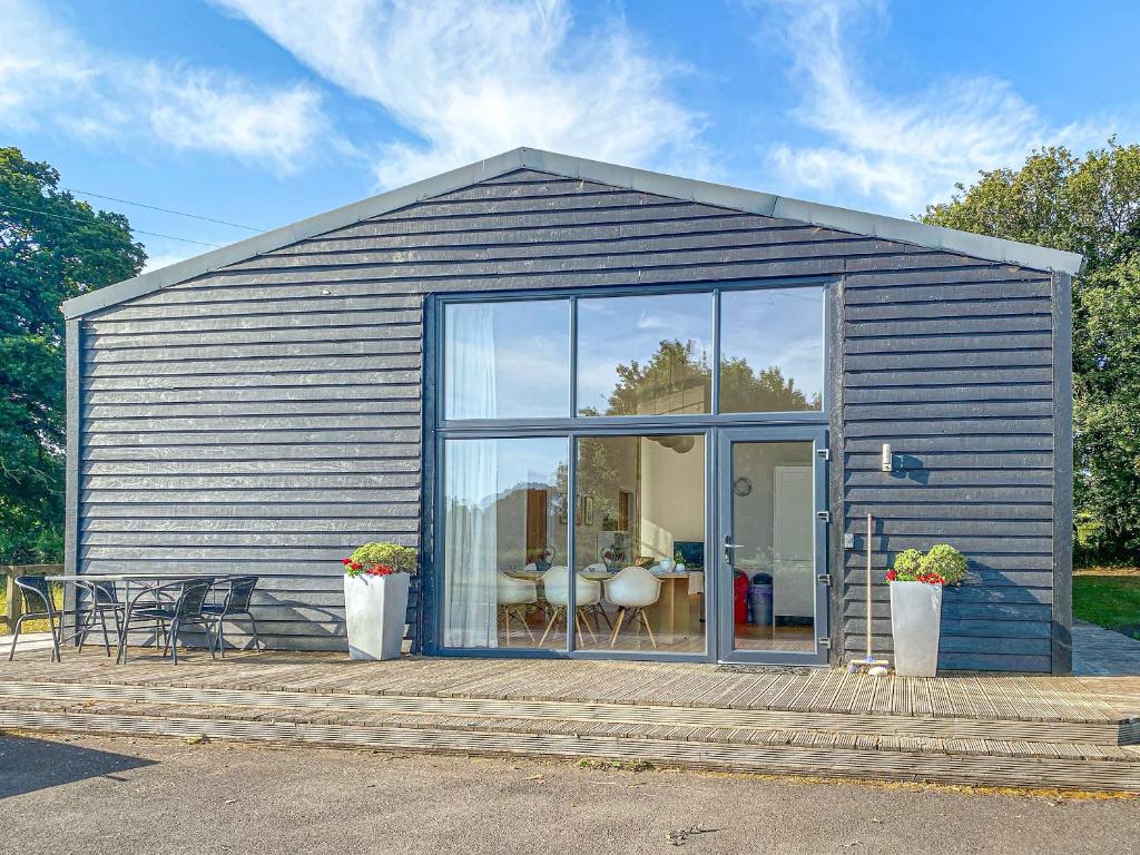 a small shed with a large window and a table at Yew Tree Barn - Hw7737 in Usk