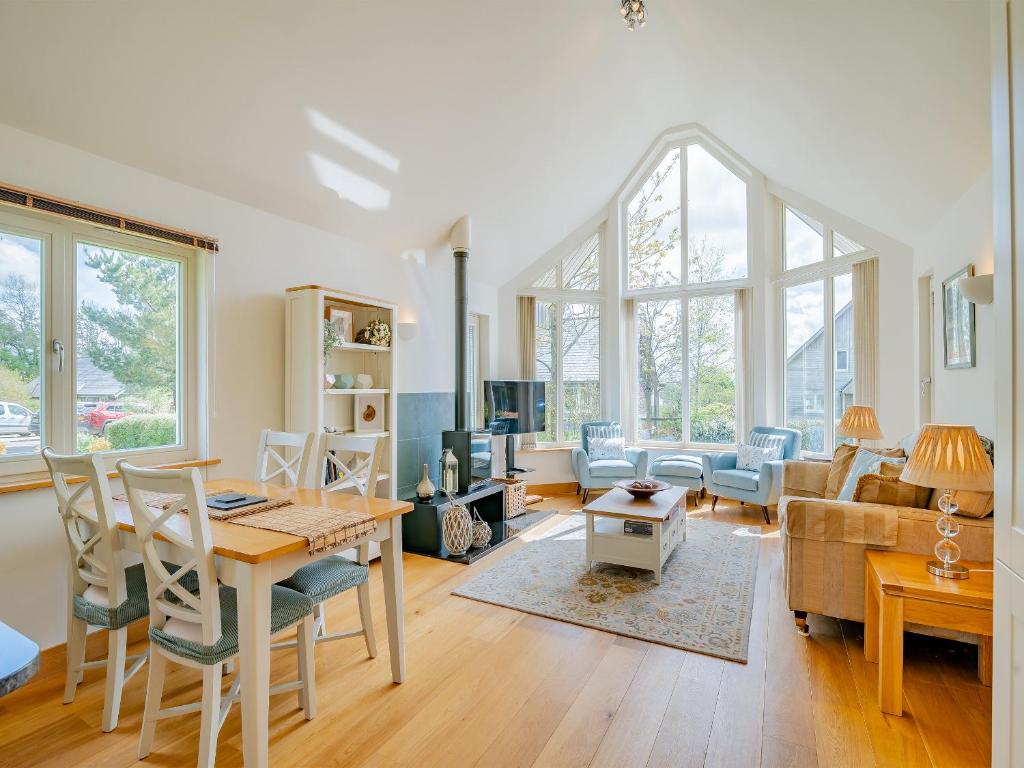 a living room with a table and chairs and a couch at Twill Lodge - 4 Swandown in Cudworth