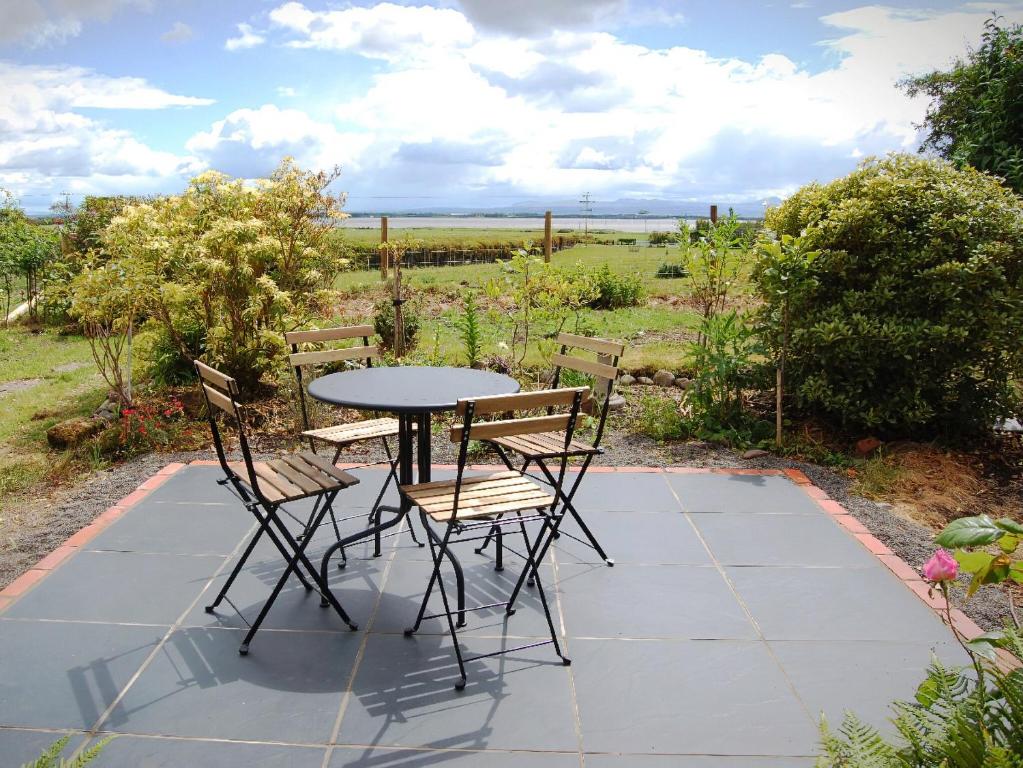 a table and chairs sitting on a patio at Summergate Cottage in Annan