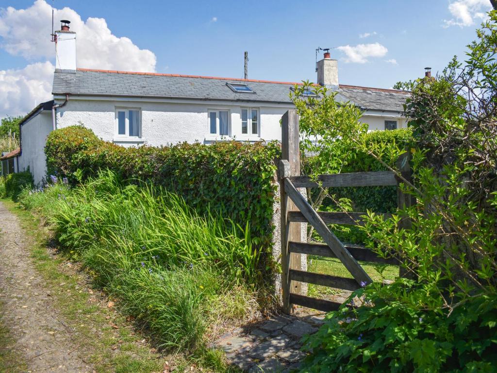 a white house with a fence and a gate at Rivers View - Uk49662 in Braunton