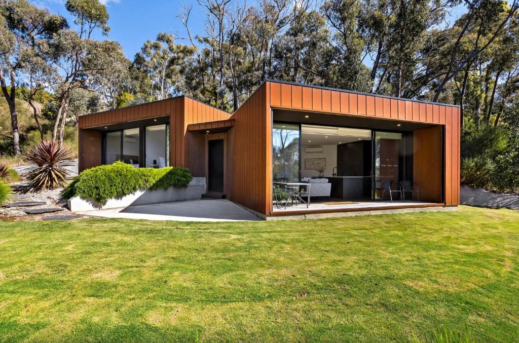 a modern house with glass doors on a yard at Lithic 2 - lovely bush views in Hepburn Springs