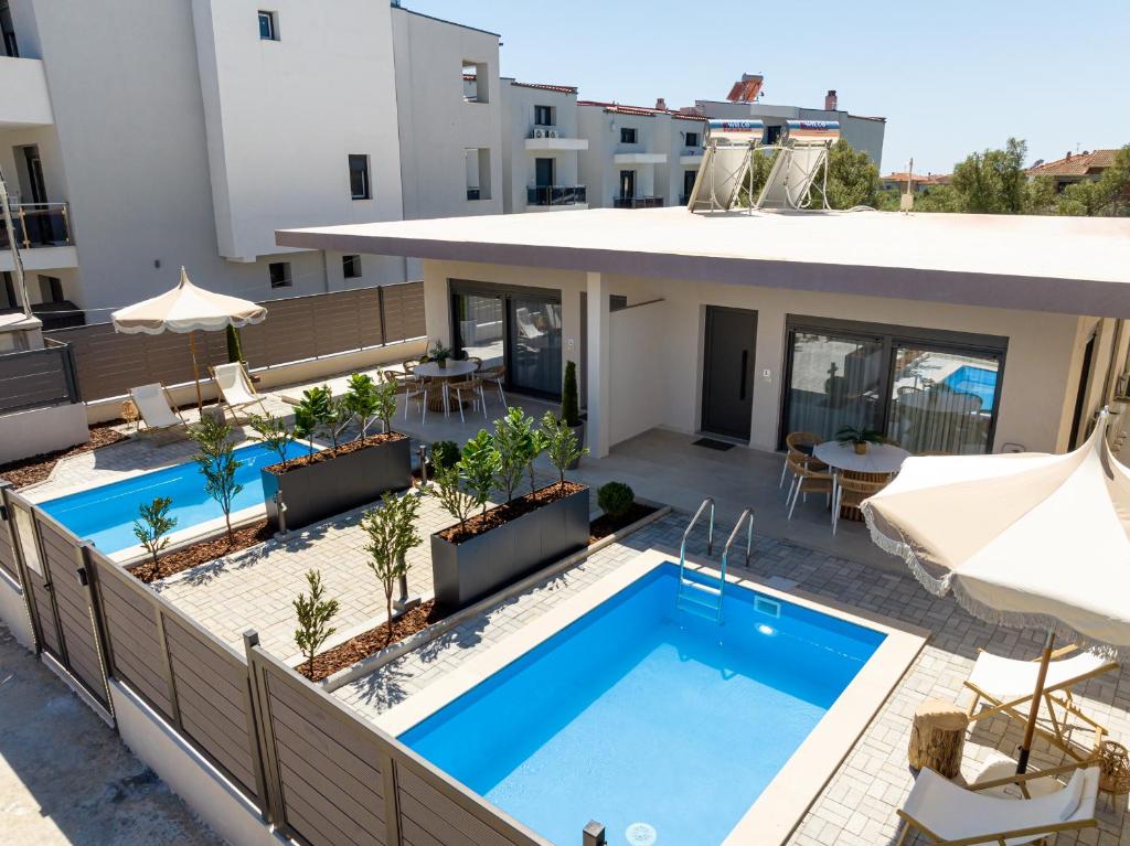 an aerial view of a building with a swimming pool at Olivio 4 Seasons Villas in Nea Moudania