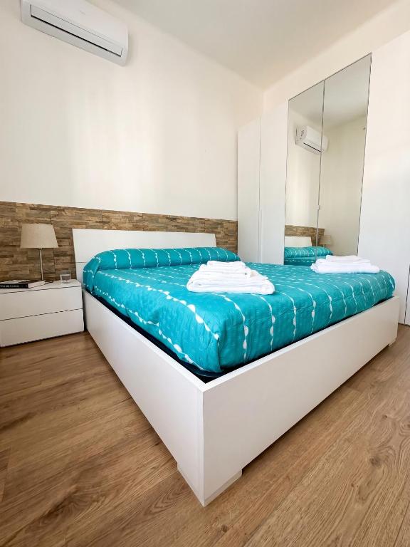a bedroom with a large bed with a mirror at ZenZone House in La Spezia
