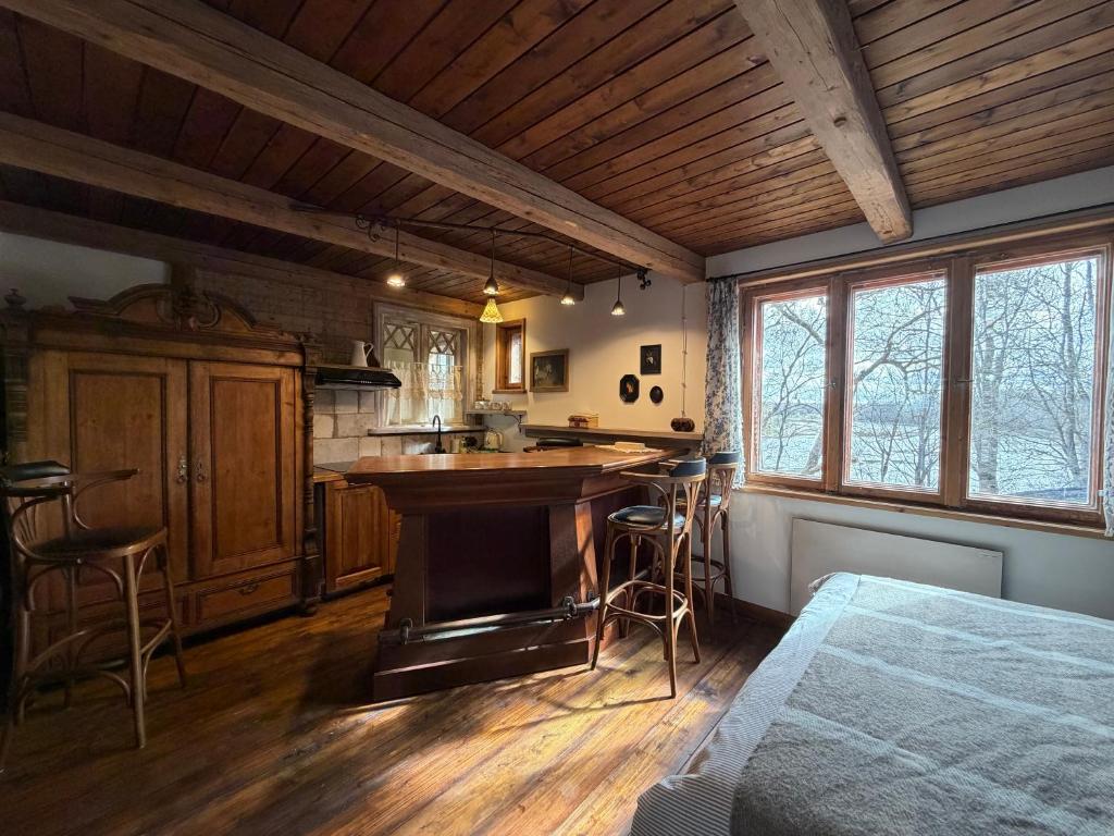 a kitchen with a counter and a table in a room at Zelta Apelsīna Rezidences in Kuldīga